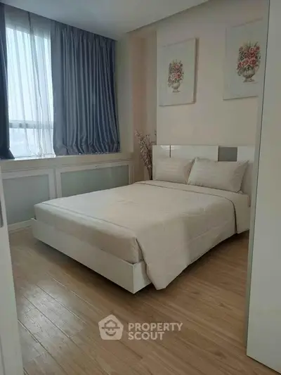 Cozy bedroom with elegant decor and natural light, featuring a comfortable bed and stylish curtains.