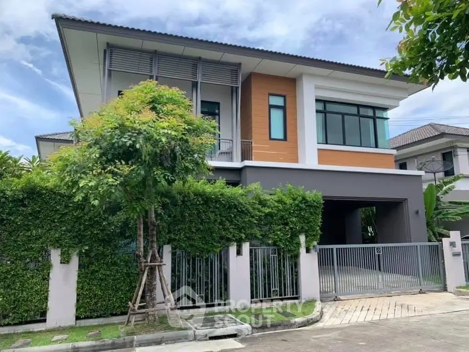 Modern two-story house with sleek design and lush greenery in a serene neighborhood.