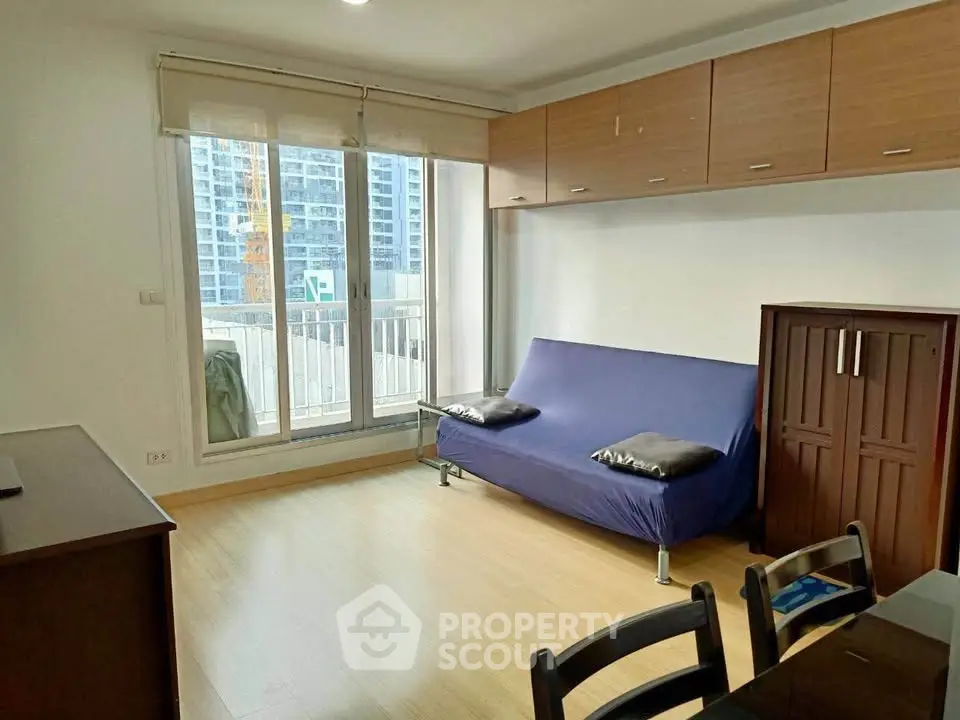 Modern living room with balcony view and stylish furniture in urban apartment