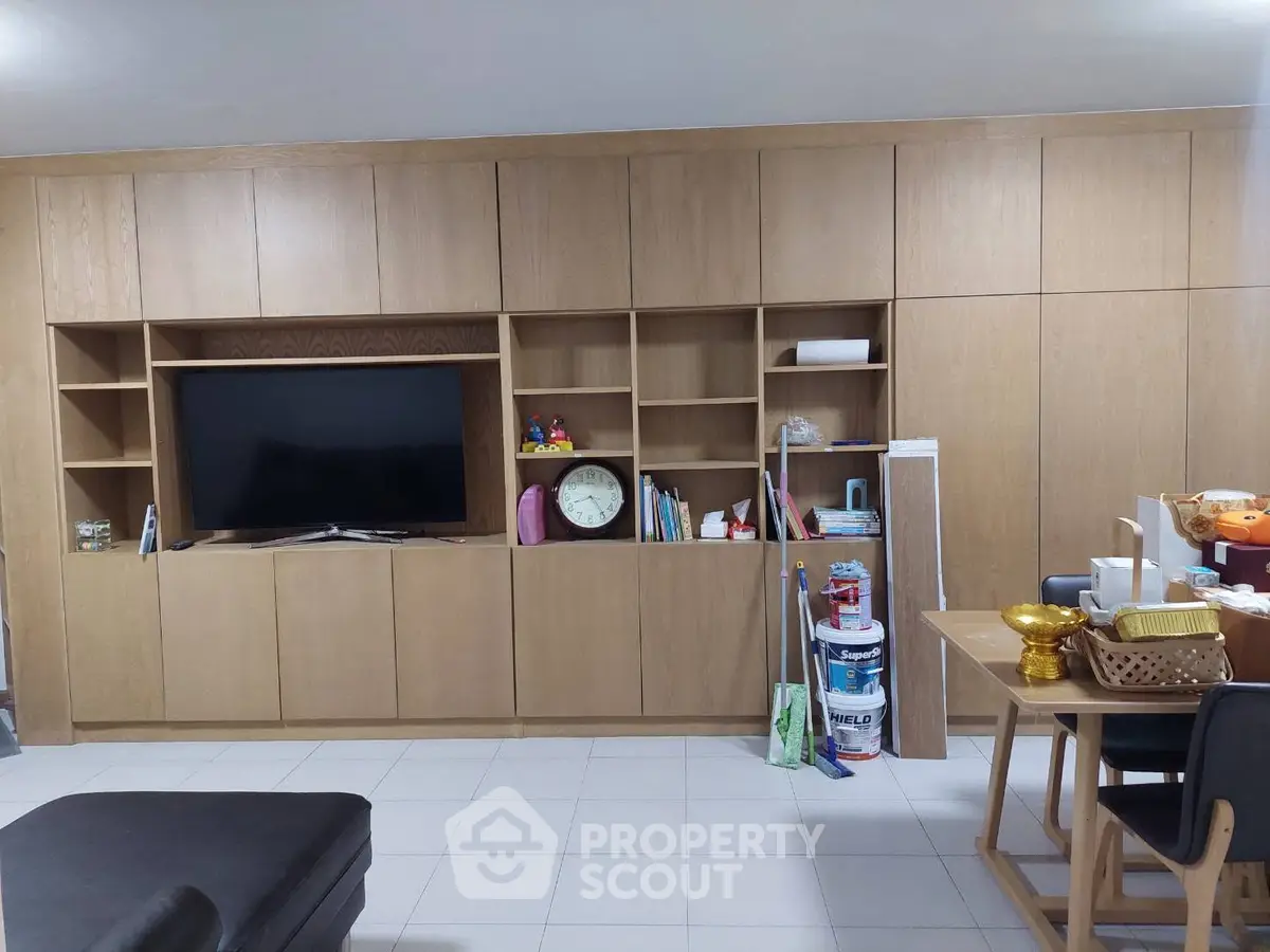 Spacious living room with built-in wooden shelves and modern decor