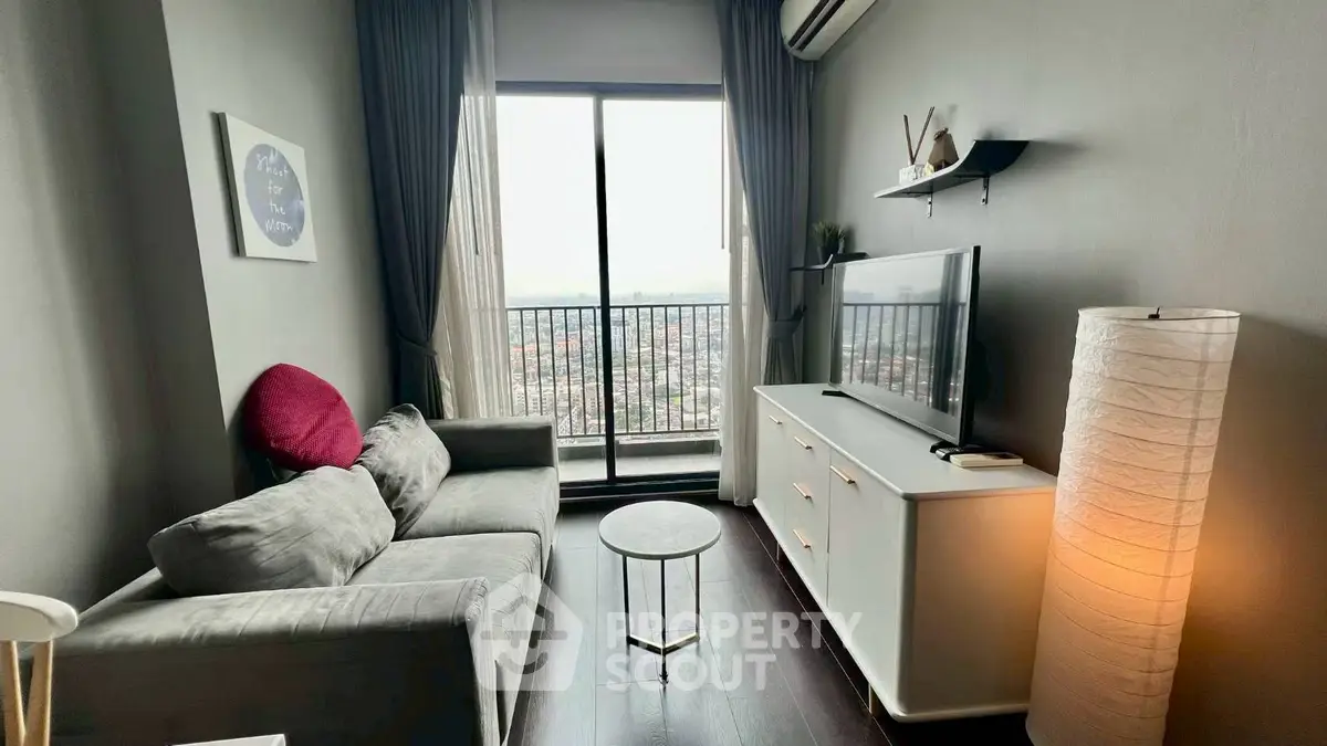 Cozy living room with balcony view, modern decor, and natural light.