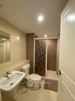 Modern bathroom with floral shower curtain and sleek fixtures