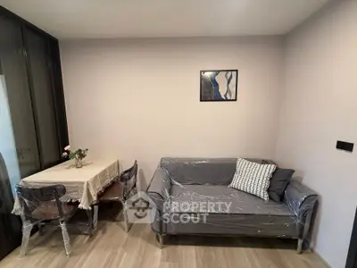 Cozy living room with modern decor and dining area, perfect for urban living.