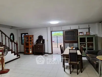 Spacious living room with dining area and classic wooden furniture