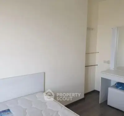 Minimalist bedroom with white furniture and natural light