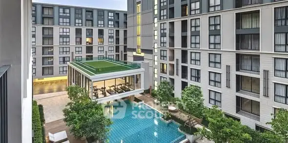Modern apartment complex with pool and green rooftop terrace, offering luxury urban living.