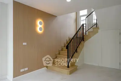 Modern staircase with wooden accents and sleek design in a contemporary home interior.
