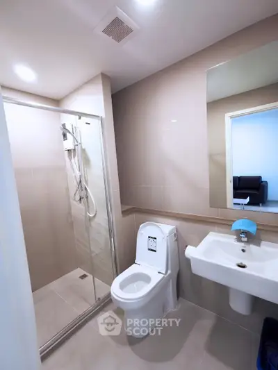 Modern bathroom with sleek fixtures and glass shower enclosure