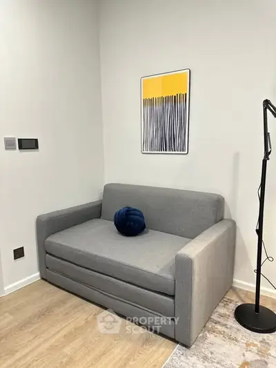 Cozy modern living room with stylish gray sofa and contemporary art.