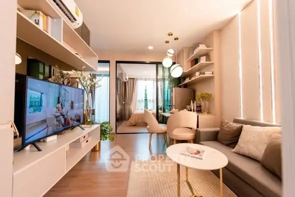Modern living room with stylish decor and open layout leading to a cozy bedroom.