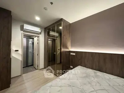 Modern bedroom with wooden accents and mirrored wardrobe in stylish apartment