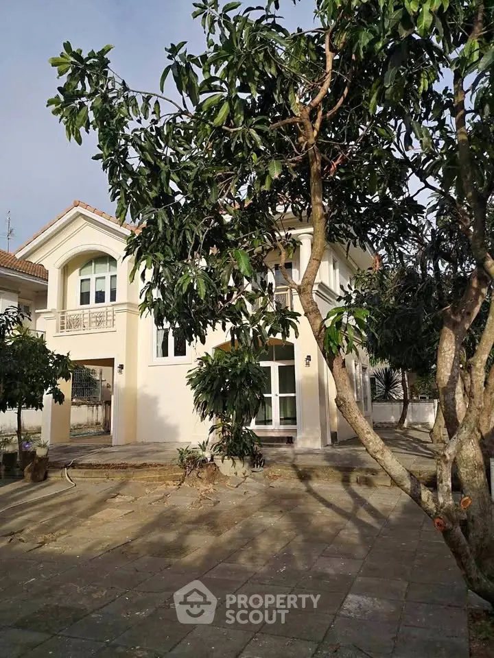 Charming two-story house with lush garden and spacious patio, perfect for family living.