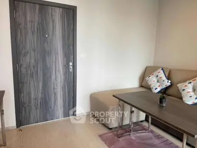 Modern living room with stylish sofa and wooden door, perfect for cozy relaxation.