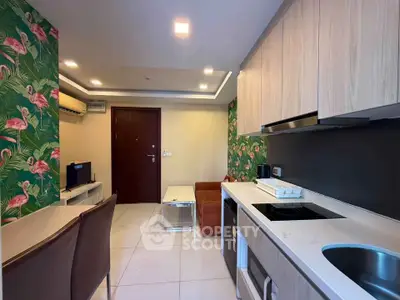 Stylish modern living room with open kitchen and vibrant flamingo wallpaper