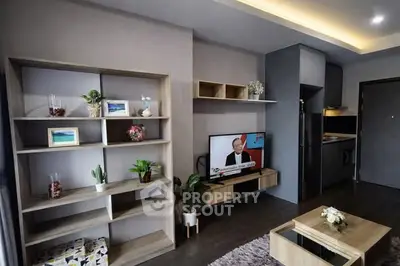 Modern living room with sleek furniture and built-in shelving, featuring a cozy ambiance and stylish decor.