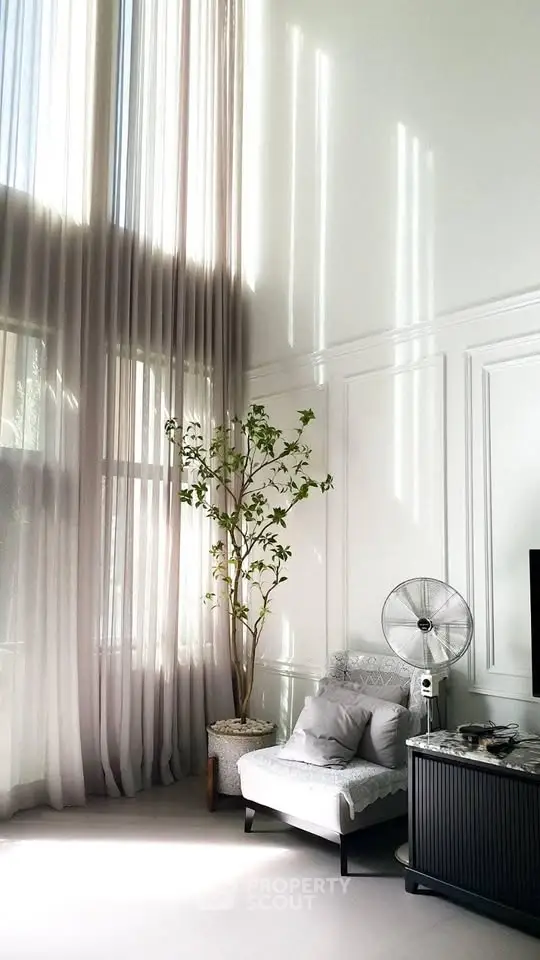 Luxurious living room with high ceilings and elegant decor