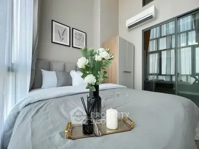 Modern bedroom with elegant decor and large windows for natural light.