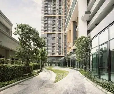 Modern residential building exterior with landscaped garden and walkway
