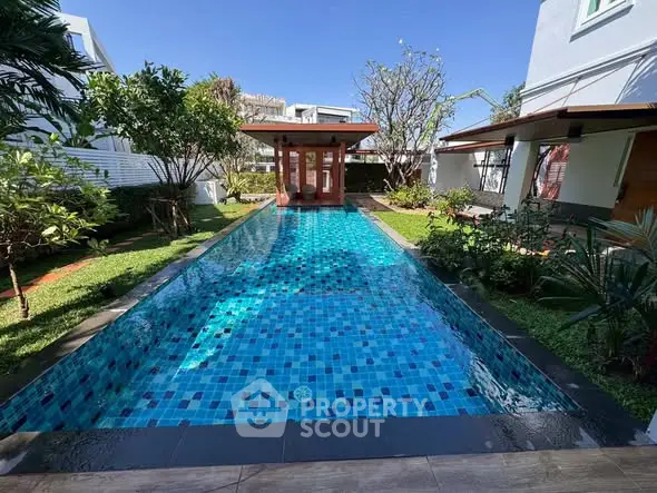 Luxurious private pool with lush garden in modern villa setting