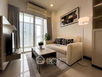 Modern living room with stylish decor and city view, featuring a cozy sofa and sleek furniture.