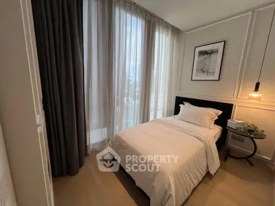 Cozy bedroom with elegant decor and large windows for natural light