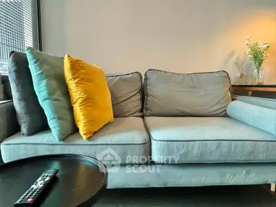 Cozy living room with stylish gray sofa and vibrant cushions, perfect for relaxation and modern living.