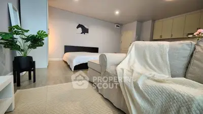 Cozy studio apartment with modern decor and comfortable furnishings