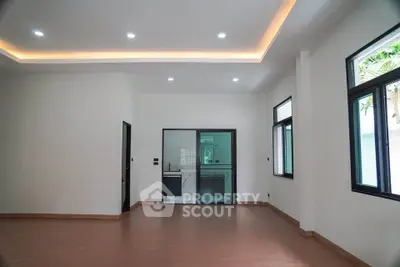 Spacious modern living room with sleek kitchen and large windows