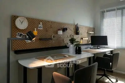Modern home office with dual desks, pegboard wall, and sleek decor for productivity.