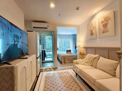 Charming living room with cozy sofa, large TV, and view into a stylish bedroom in modern apartment.