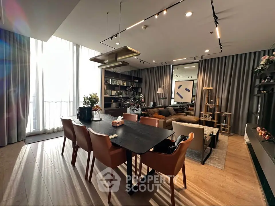 Luxurious modern living room with elegant dining area and floor-to-ceiling windows.