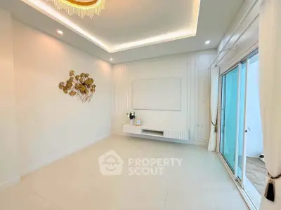 Spacious modern living room with elegant decor and large sliding glass doors.