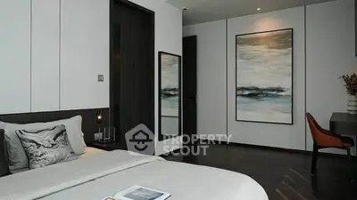 Modern bedroom with elegant decor and dark wood flooring