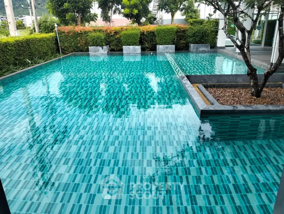 Luxurious outdoor pool with modern design and lush greenery, perfect for relaxation and leisure.