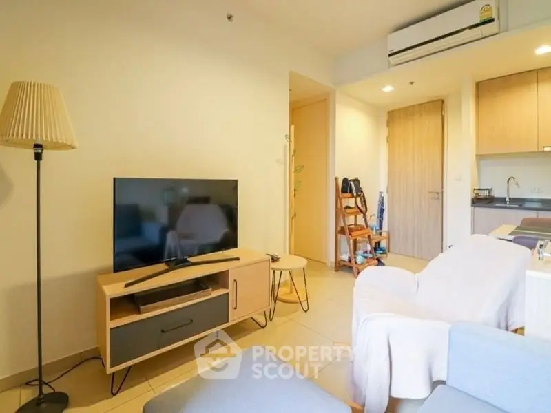 Cozy living room with modern furniture and open kitchen layout