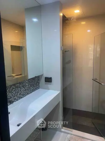 Modern bathroom with sleek design and glass shower enclosure