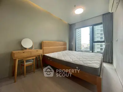 Modern bedroom with large window and wooden furniture in city apartment