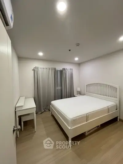 Spacious bedroom with modern furnishings and natural light, perfect for comfortable living.