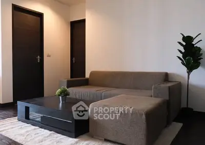 Modern living room with stylish sofa and coffee table, perfect for relaxation.