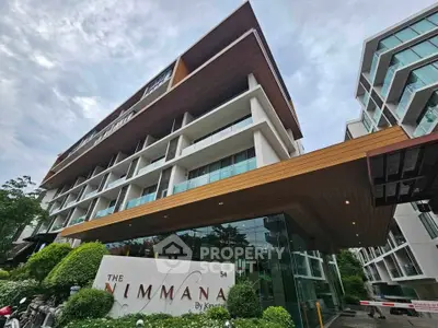 Modern condominium building with sleek architecture and lush greenery at The Nimmana by Keyne.
