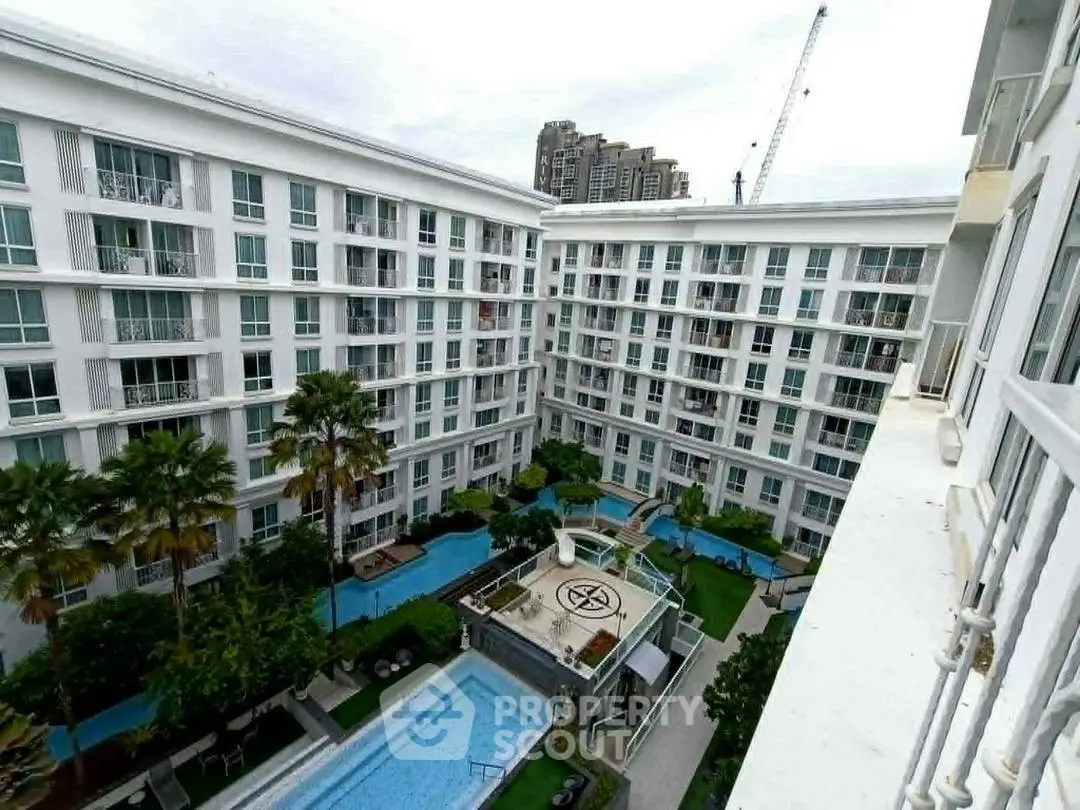 Luxurious apartment complex with pool and lush gardens, perfect for modern living.