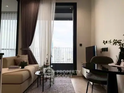 Modern living room with elegant decor and city view balcony, featuring cozy seating and stylish furnishings.
