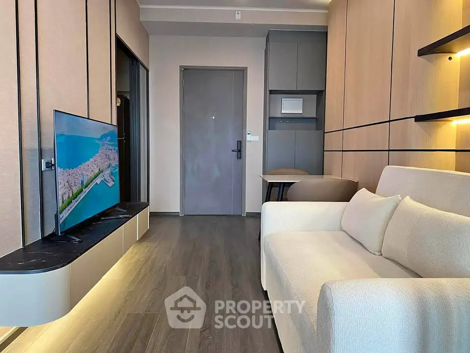 Modern living room with sleek design, featuring a wall-mounted TV and cozy sofa, perfect for urban living.