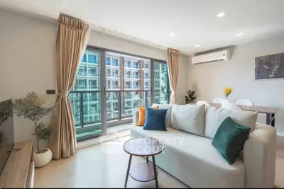 Modern living room with large windows and stylish decor in a high-rise apartment