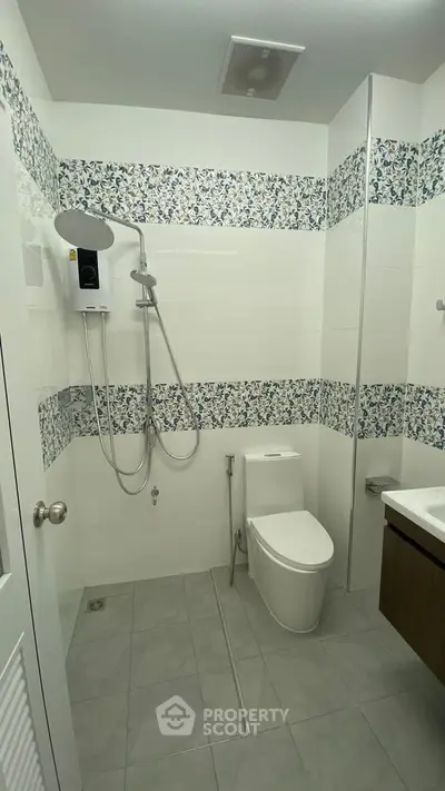 Modern bathroom with floral tile accents and sleek fixtures