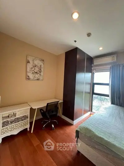 Cozy bedroom with study area and large window view