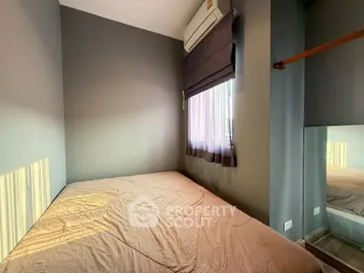 Cozy bedroom with natural light and modern air conditioning unit.