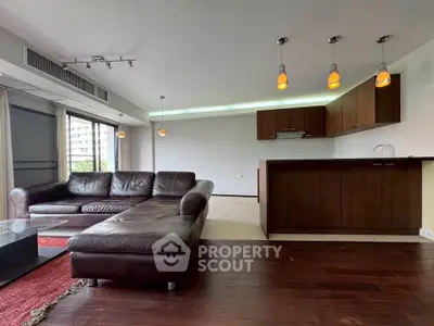 Spacious modern living room with open kitchen and stylish lighting