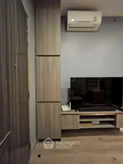 Modern living room with sleek TV unit and air conditioning