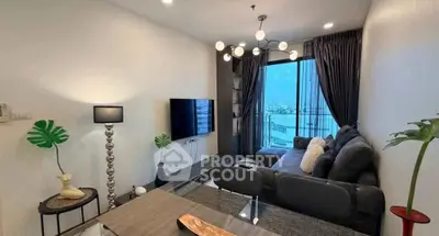 Modern living room with stylish decor and balcony view in urban apartment.